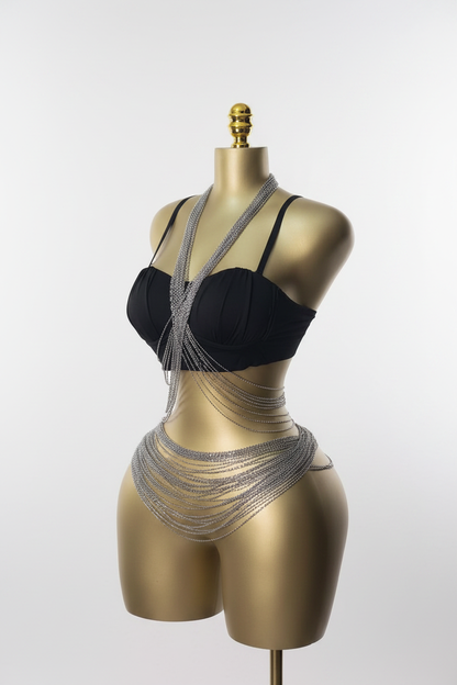 Layered silver body chains on gold mannequin white background